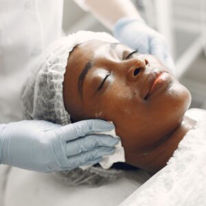 Woman getting facial exfoliation treatment 