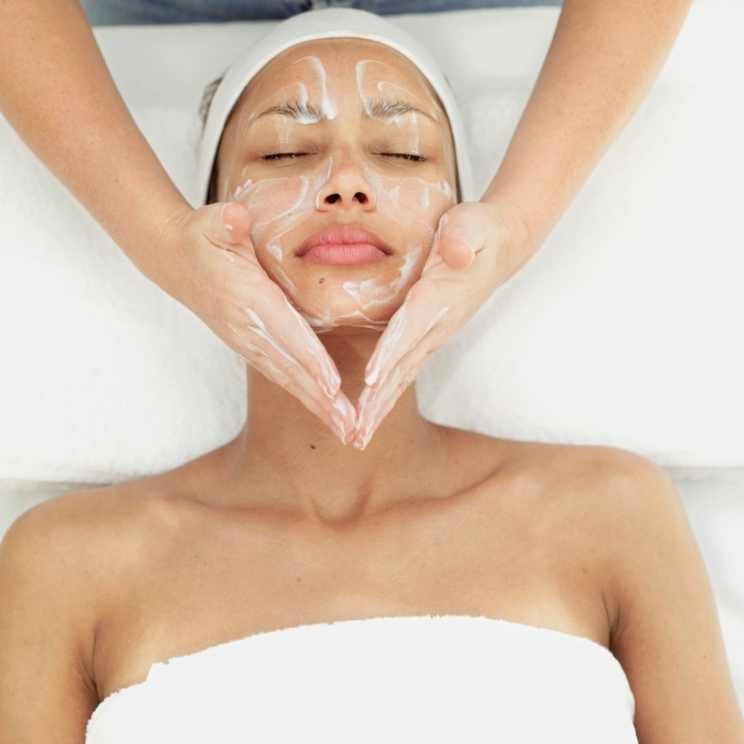 woman getting cleansing facial